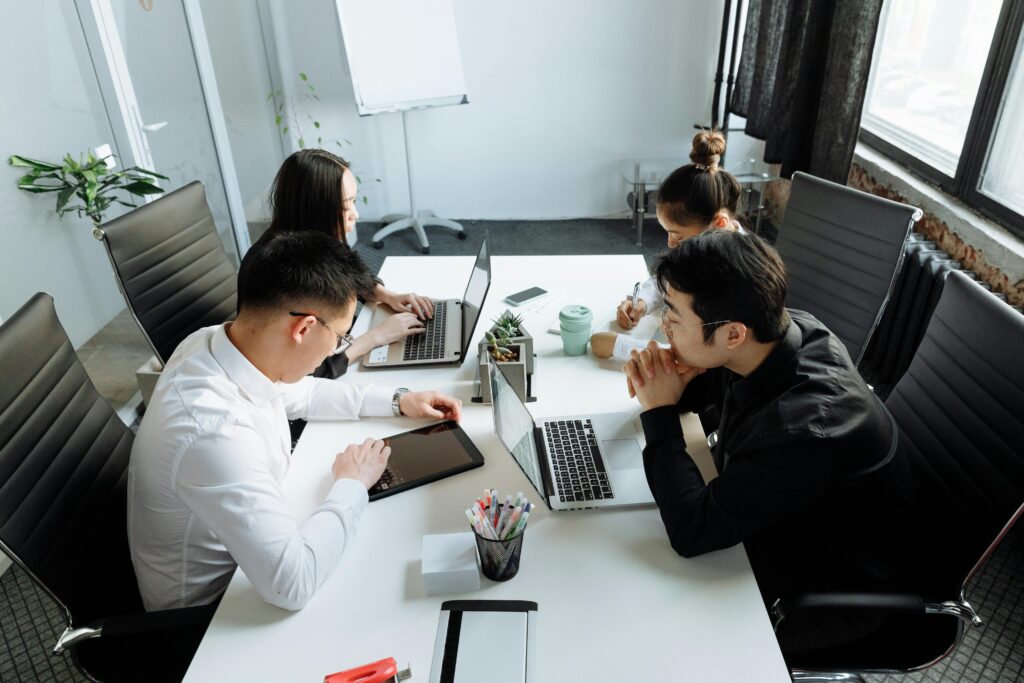 Team of young professionals engaged in collaborative work at a modern office setting.